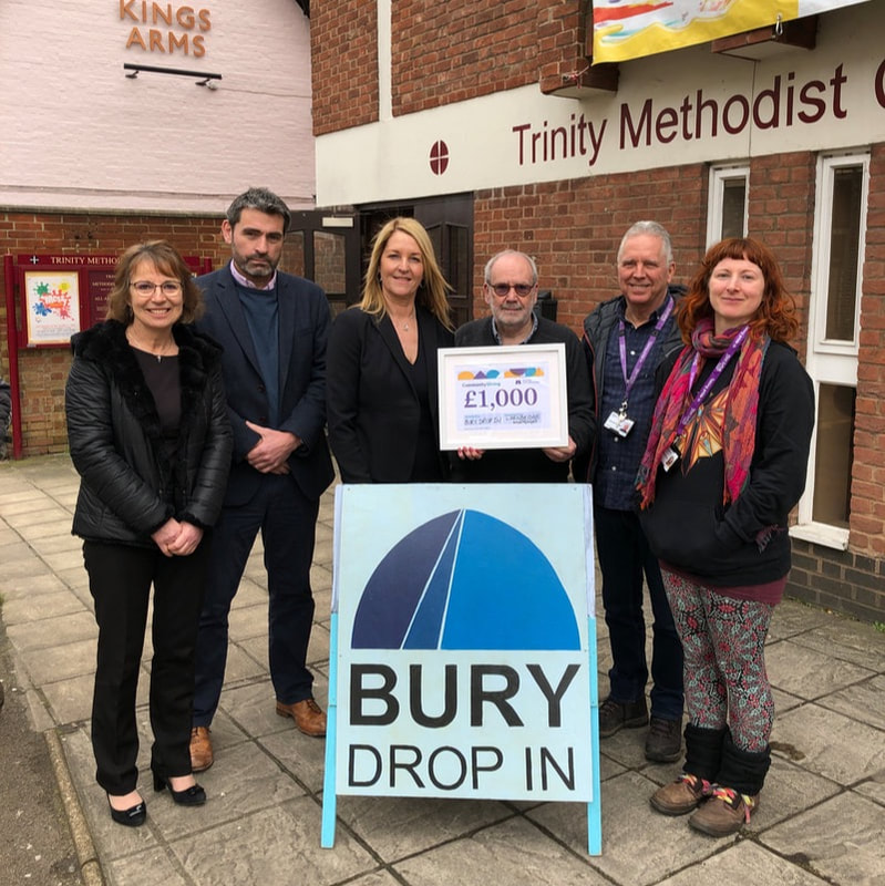 Bury Drop In receiving a donation from Skipton