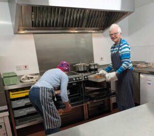 Volunteers serving up lunch in the new kitchen