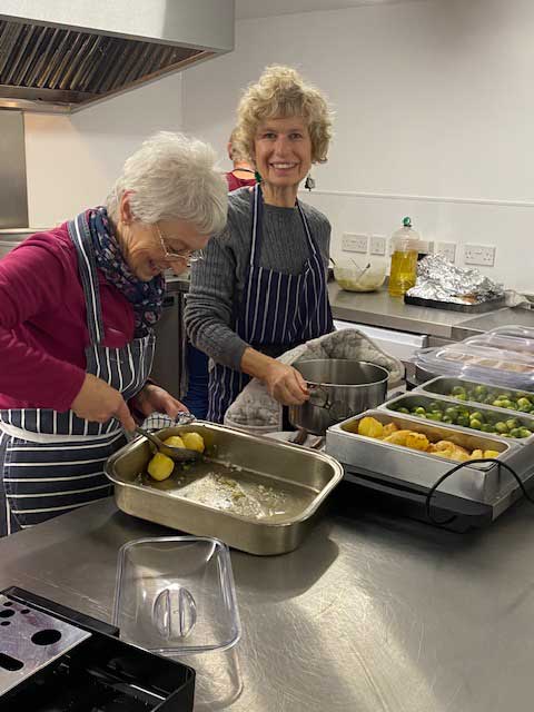 Volunteer cooks serving Christmas lunch